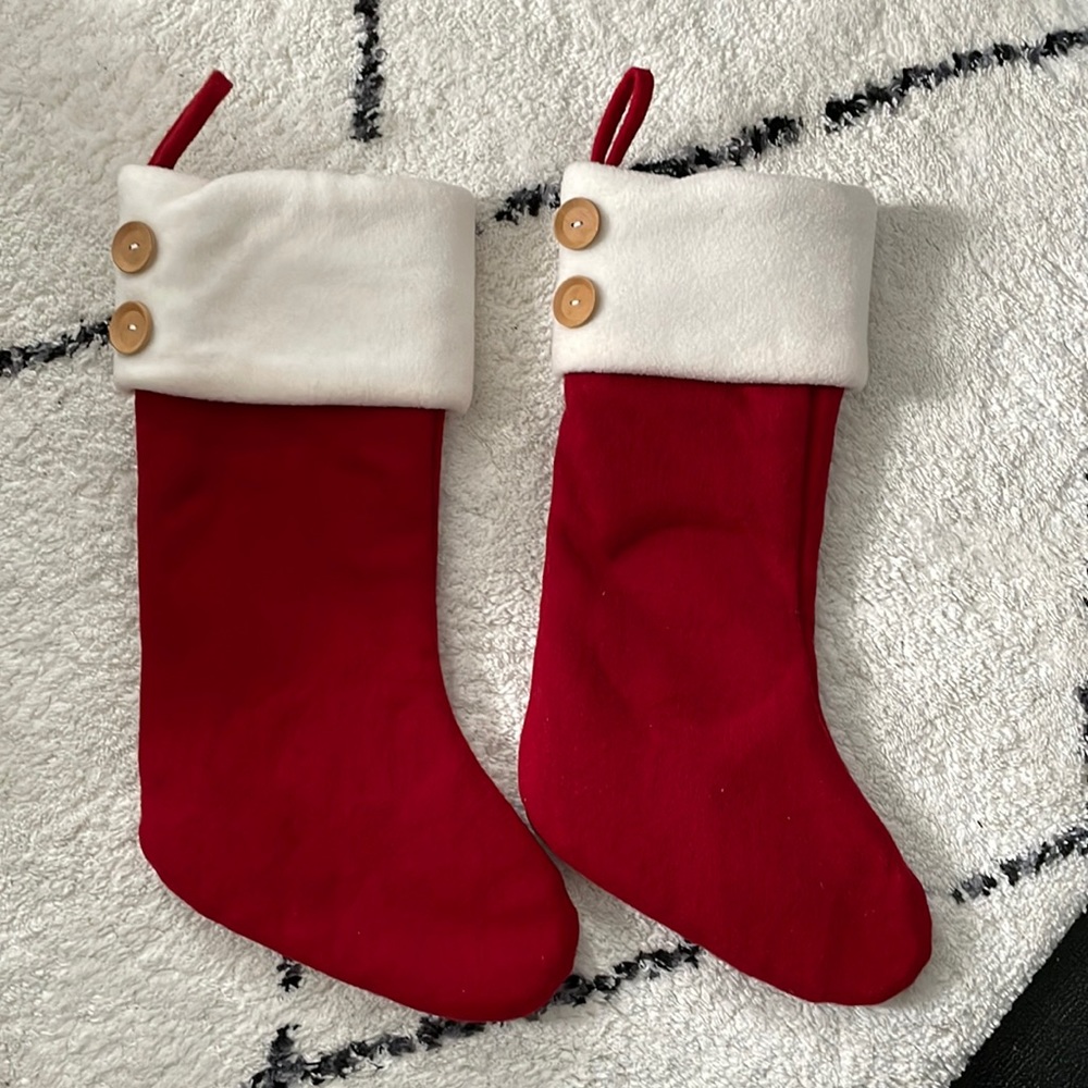 Pair of red stockings with wooden buttons.